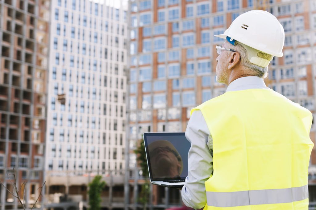 man holding laptop signifying BIM project management.