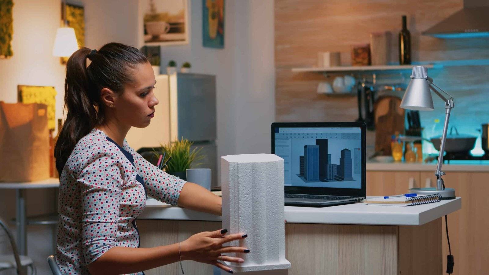 image of a woman holding a construction model through building information modeling services.