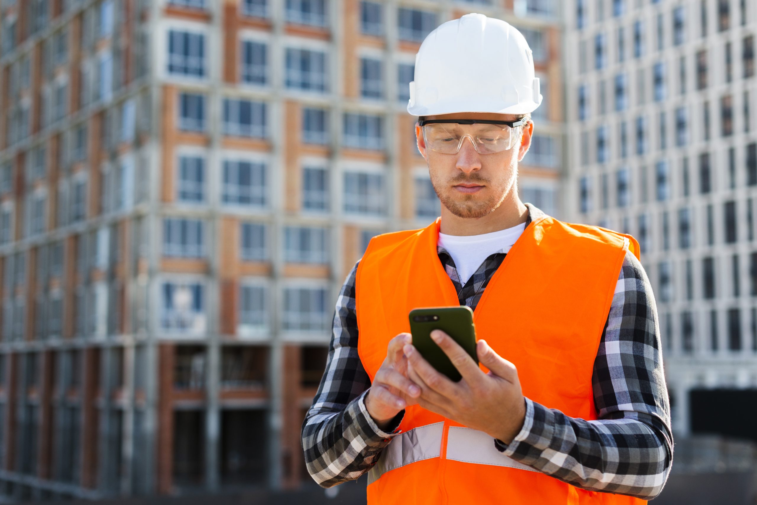 construction worke using phone signifying BIM project management services