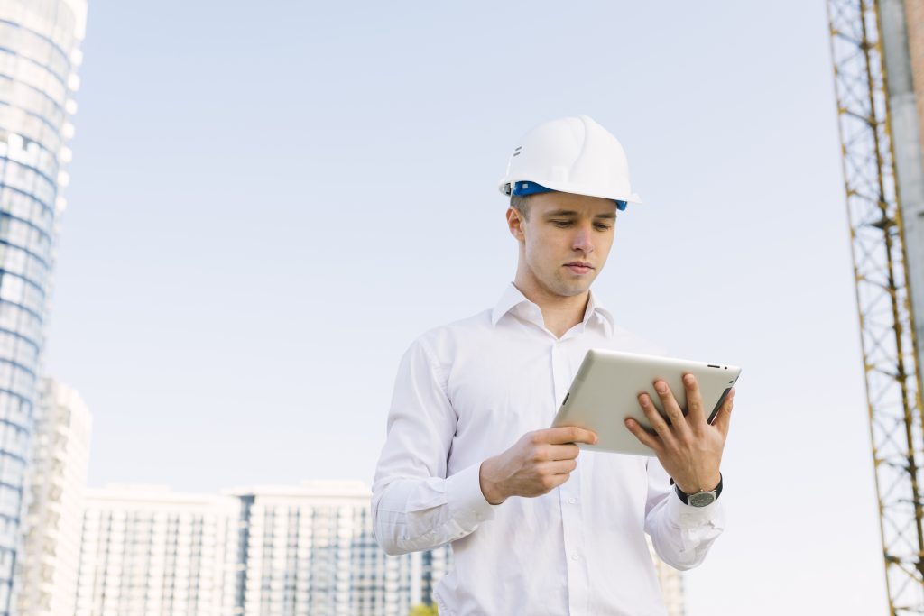 man holding laptop signifying benefits of BIM in construction