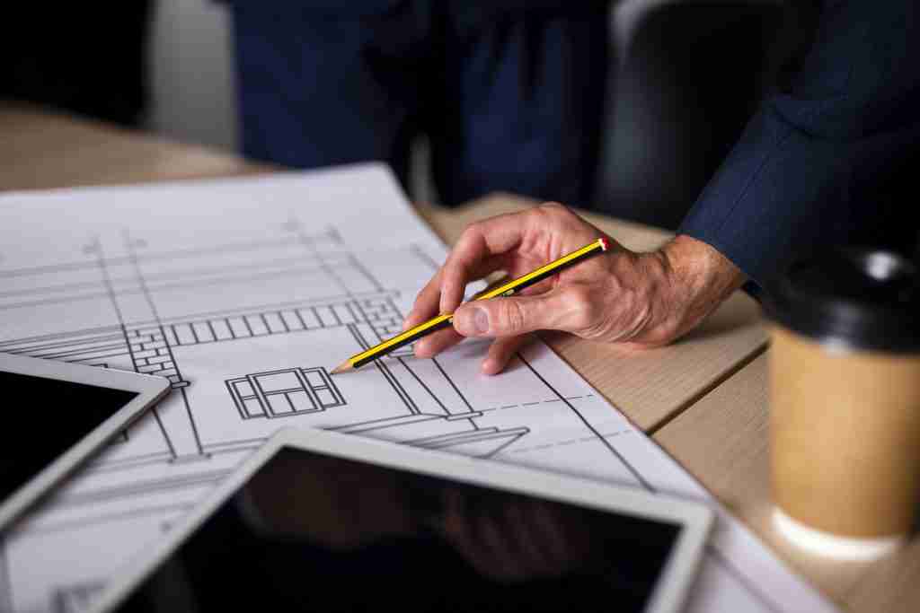 architect checking fabrication drawings for building.