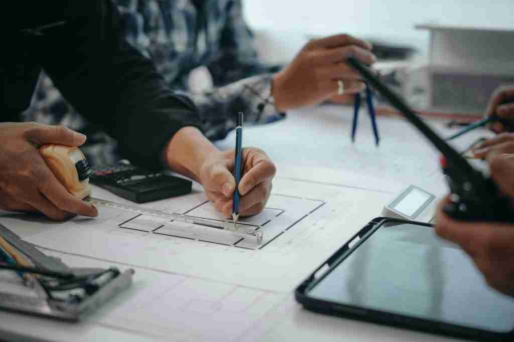 man writing on architectural plan using architectural BIM services.