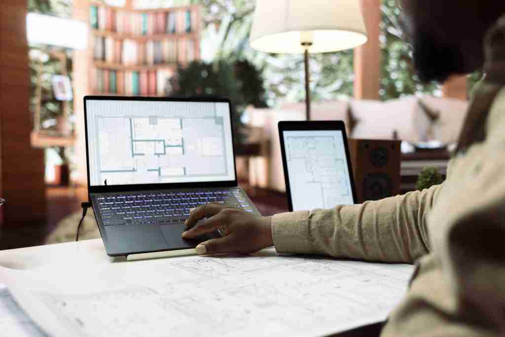 image of man using laptop signifying the use of revit architecture 3d models for project.
