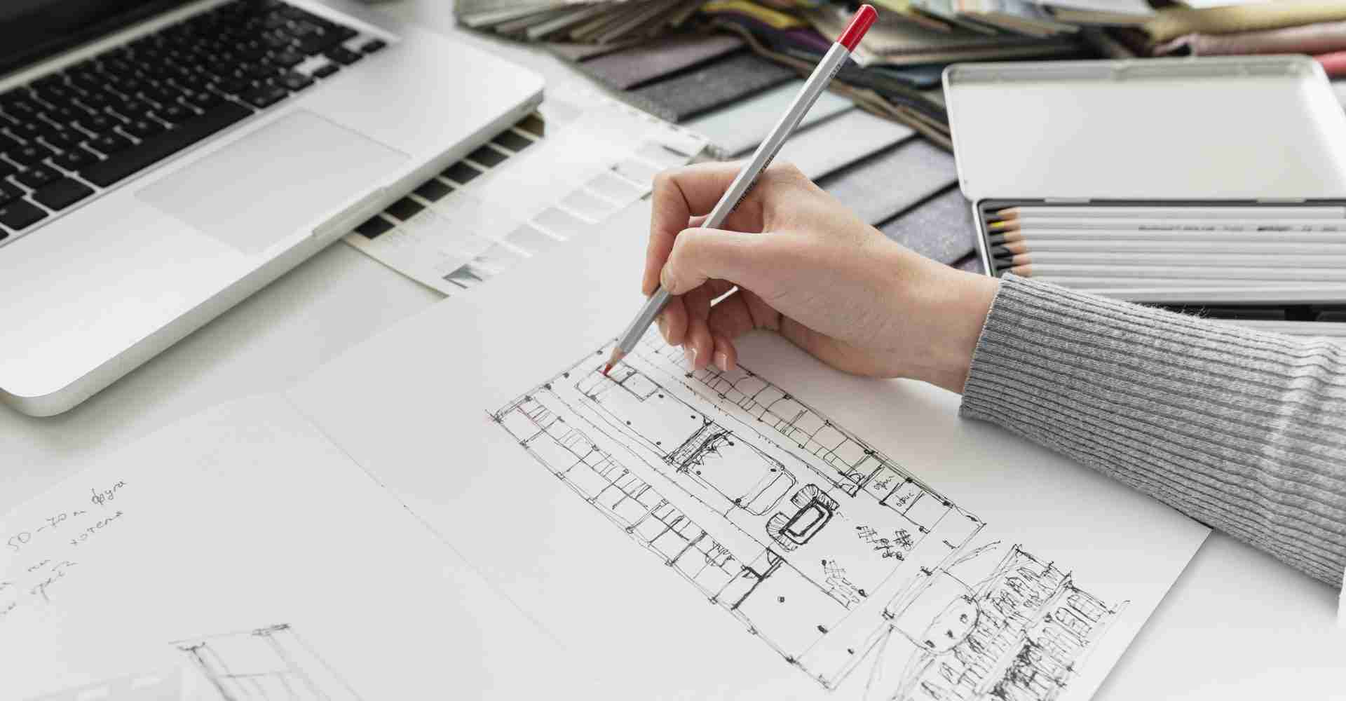 close up hand working on laptop using architectural drafting for building project.
