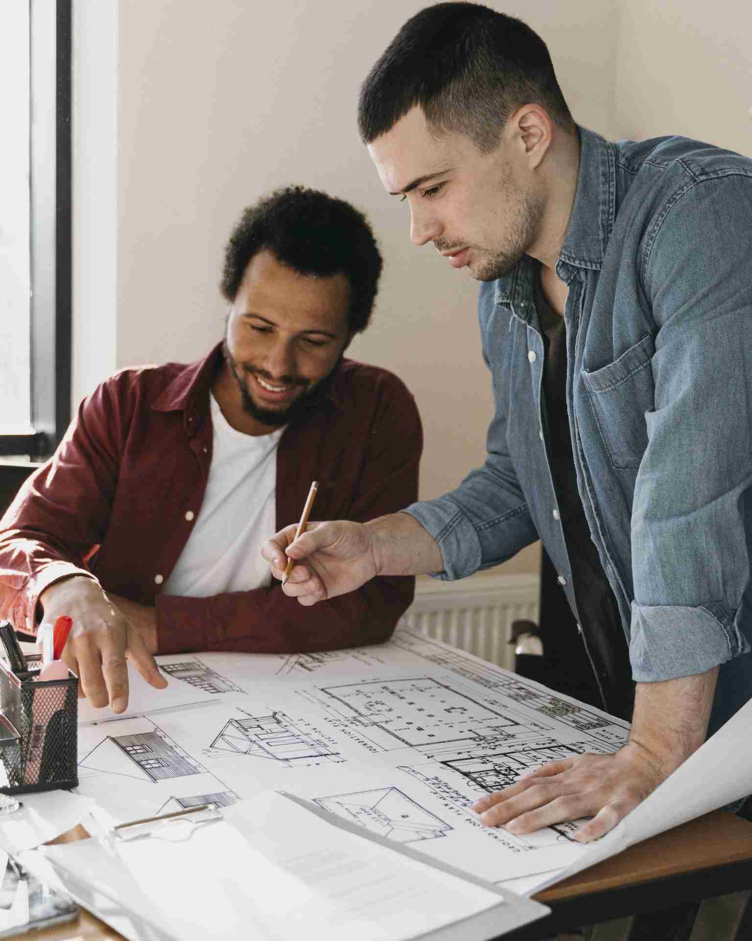 two architects working on residential project using residential design services.