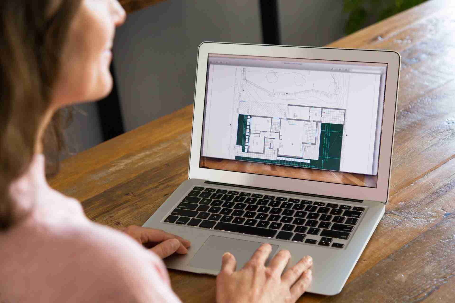 architect using residential design services on laptop.