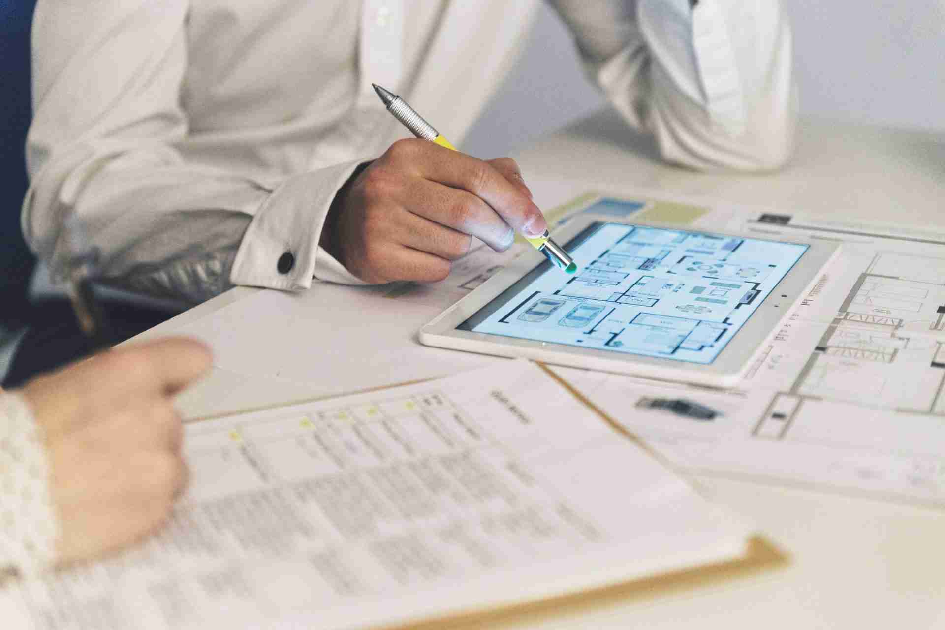 image of tablet and document signifying the use of BIM software such as revit and archicad.